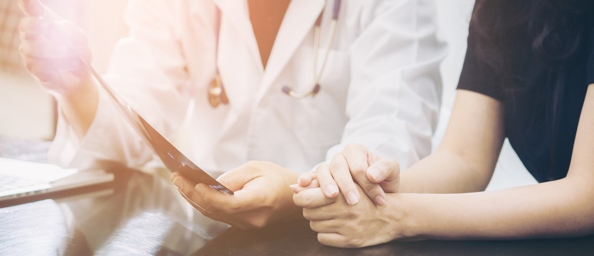 A doctor and patient reviewing information.  